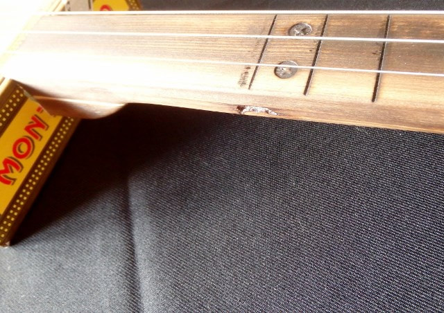 Wood cigar box guitar fretboard with burned fret markers from Wires and Wood.