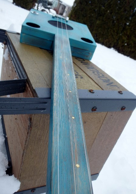 Turquoise cigar box guitar neck.
